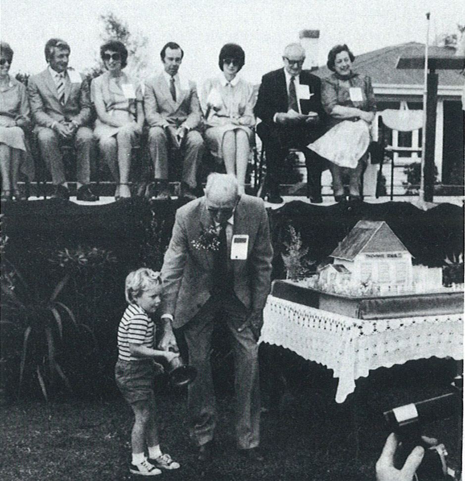 School Centenary: Mr R. Werner end R. Verner ring the bell, beside the School Cake.